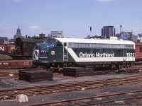 Ontario Northland 1521, one of three FP7s painted in the "Progressive" paint scheme (the others were 1502 and 1517), idles at CN's Spadina facilities in the spring of 1966.  Steam crane CN 50834 can be seen behind the unit.<br><br><i>Doug Page Photo, Bruce Acheson Collection Slide.</i>