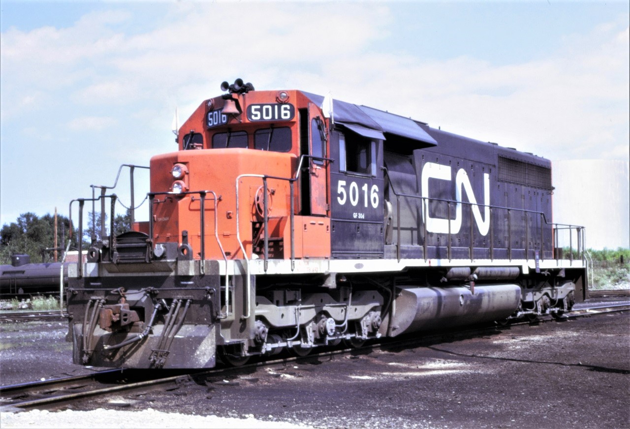 CN SD40 5016 rests on the shop track in Capreol, Ontario on July 29, 1972.  The unit, class GF30d, was built by GMDD in 1967.