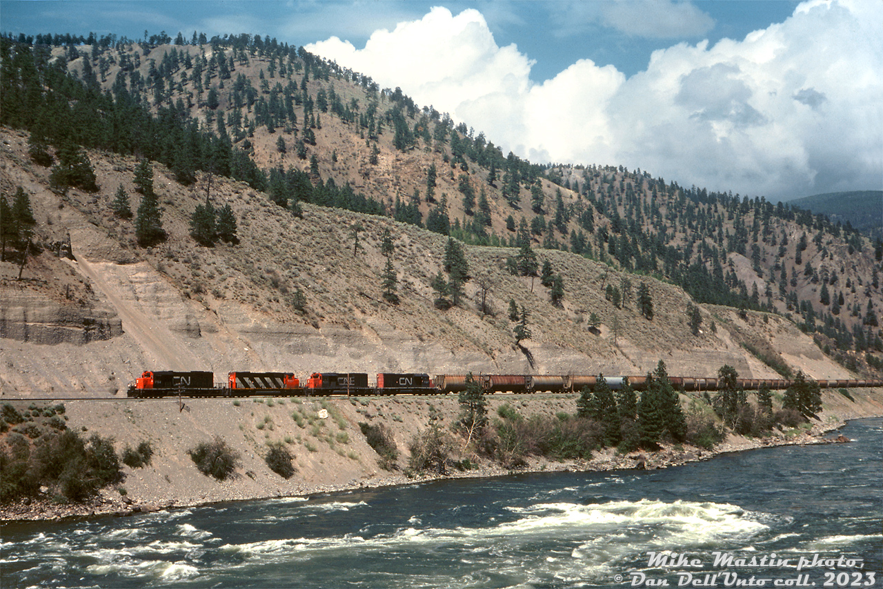 3000 horsepower GMD muscle moves potash through the Thompson Canyon: CN SD40 units 5102, 5231 and 5187 work with SD40-2W 5267 hauling a long westbound potash train of covered hoppers along the Fraser River in the Thompson Canyon (not sure of the exact location, but it's somewhere south of Lytton).

Mike Mastin photo, Dan Dell'Unto collection slide.