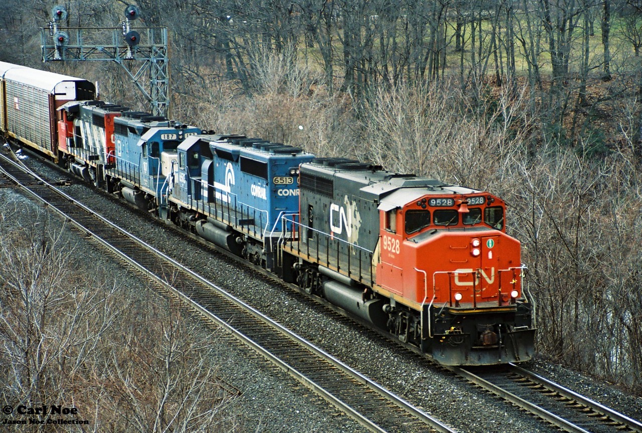 A CN eastbound rolls through Bayview Junction in Burlington to Toronto on the Oakville Subdivision with GP40-2L(W) 9528, Conrail SD40-2 6513, EMDX GP40 187 and another CN GP40-2L(W). EMDX 187 started out life as MKT 187 in September 1967.