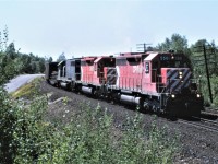 A trio of SD40s lead an eastbound freight a couple of miles out of Sudbury Ontario on August 3, 1987.  CP 5501 and 5553 lead leased SD40 HLCX 5076 which began life as MP 776, then to GATX 5076 and finally to HLCX 5076.