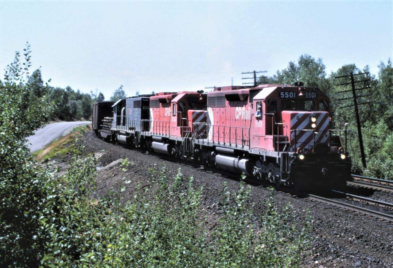 A trio of SD40s lead an eastbound freight a couple of miles out of Sudbury Ontario on August 3, 1987.  CP 5501 and 5553 lead leased SD40 HLCX 5076 which began life as MP 776, then to GATX 5076 and finally to HLCX 5076.