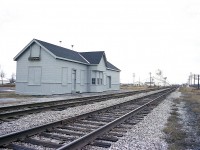 The old MCR/PC/CR station in Ridgetown. Boarded up and given a solid grey paint-over. Not really sure why. Conrail took over earlier in the year, so perhaps this is their idea of sprucing up existing property.   I had thought this structure demolished when I went thru town about 10 years ago, but apparently it was sold and moved and is now a private residence on Edward St in town.
This image posted is looking west.