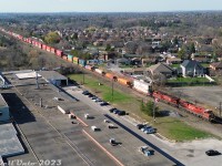 On the "Last Day of CP" for Canadian Pacific as its own corporate identity, before becoming part of the CPKC merger borg, it was the first day of dispatching the foam drone high over Woodbridge: CP 8857 and 9803 back their intermodal train up the MacTier Sub into Vaughan Intermodal Terminal, after having pulled ahead and stopped short of the crossing at Kipling Avenue in downtown Woodbridge.<br><br>The train is seen clearing the private crossing to Woodbridge Foam, a longtime local industry that began as Robinson Cotton Mills Ltd in the 1920's, before branching into urethane foam in the 1950's (for cushioning, furniture and automotive products) as Robinson Moulded Products Ltd and Robinson Foams Ltd. At one point they had their own private rail siding off the Woodbridge siding/passing track here. The plant, now Woodbridge Foam Ltd, is still active here, with a branch in Kitchener as well. The Canadian flag flying trackside out front is a nice touch.<br><br>As for CPKC? Simply put, we'll see what happens tomorrow.<br><br><i>(Special thanks to the young couple who volunteered a spare water bottle on this warm day, after an unfortunate non-drone, non-rail related transportation occurence).</i><br><br><i>Note: RPAS piloted with compliance to all of Transport Canada's "Micro Drone" rules and regulations.</i>