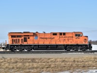  Travelling West along the Trans-Canada Highway West of Broadview SK and passed this Eastbound, CP#113. Did a quick U-Turn and the chase was on. The highway was pretty slick with drifting snow and ice, so as I attempted to keep the car out of the ditch, my daughter Julia took this pan shot through the open driver side window. We eventually got far enough ahead and found a road crossing for the back-lit wedgie.  