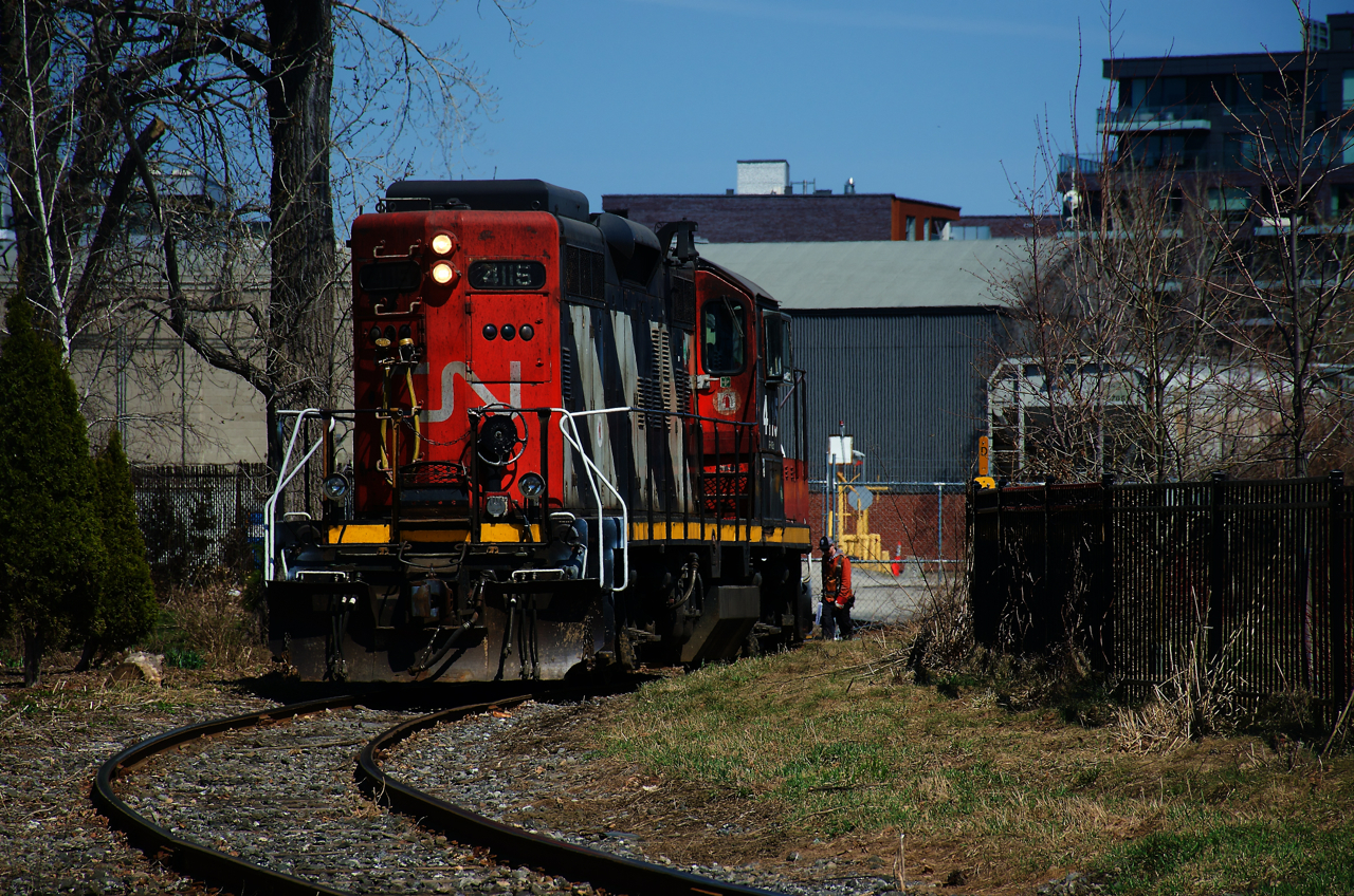 A crewmember has just closed the gate at Ardent Mills after CN 4115 brought three grain cars there.