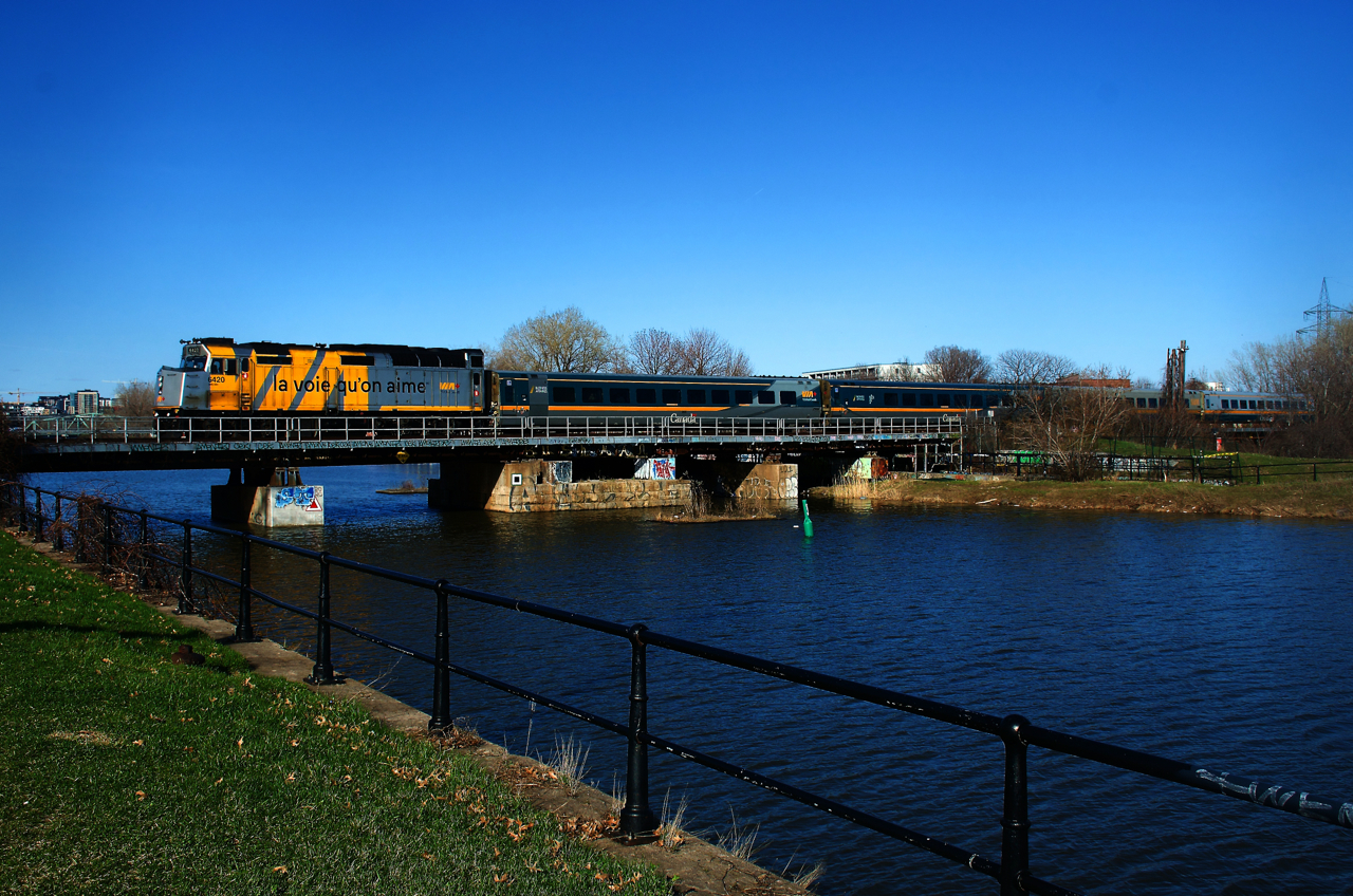 VIA 37 for Ottawa crosses the Lachine Canal with a wrapped F40 leading.