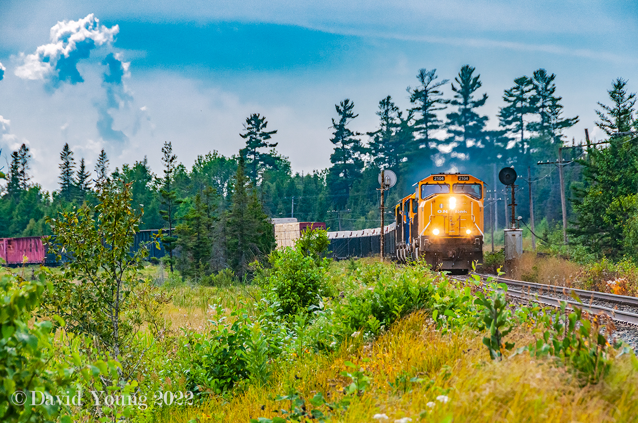 Having dropped a flatcar (presumably to load some new culverts) at the back track in Temagami, Englehart bound freight 113 is back up to track speed with their respectable sized freight and six locomotives 2104-1805-PRLX 2270-2101-2102-2105. Storm clouds are building and by the time the train reaches Englehart, the crew will have to yard their train under threat of Tornado Warnings.