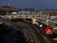 CN 321 is passing Turcot Ouest with a pair of EMD units for power. At left are cars set off earlier that day by CN 527. CN X309 was supposed to pick them up, but it would fall to the next edition of CN 321 to do so.