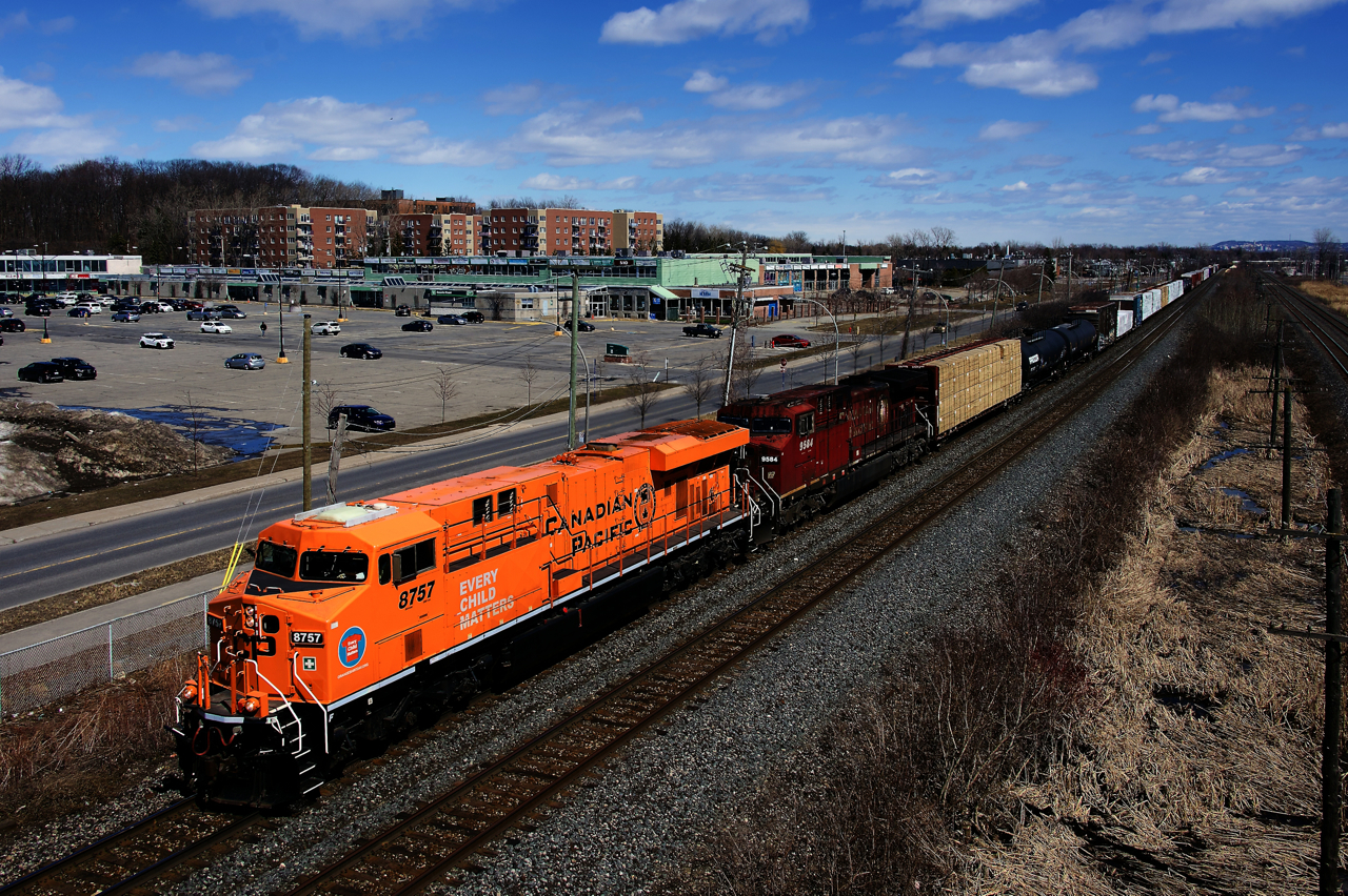 One of CP's cleanest and one of its dirtiest units (CP 8757 & CP 9584) are paired together as they lead a 96-car CP 231 westbound on the North Track of the Vaudreuil Sub. Reportedly CP 9584 is the last 9500-series CP unit still active. CP 8757 was painted into this special paint scheme in September 2021 and it honours residential school victims.