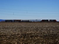 CN 522 has one car for BarretteWood and three cars for Nova Grain as it passes a barren field on the approach to Saint-Jean-sur-Richelieu.