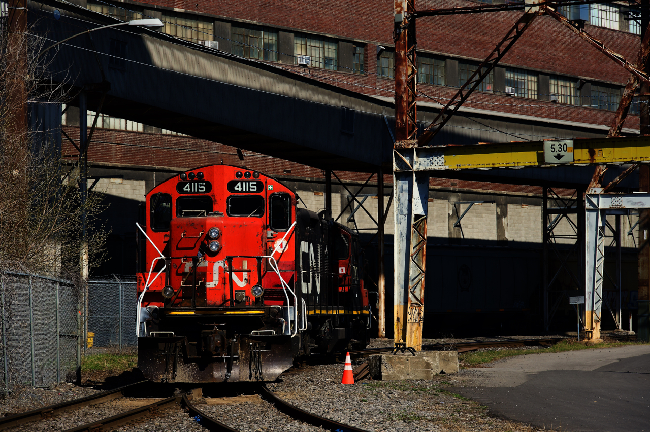 A pair of GP9s are backing up as they switch grain cars.