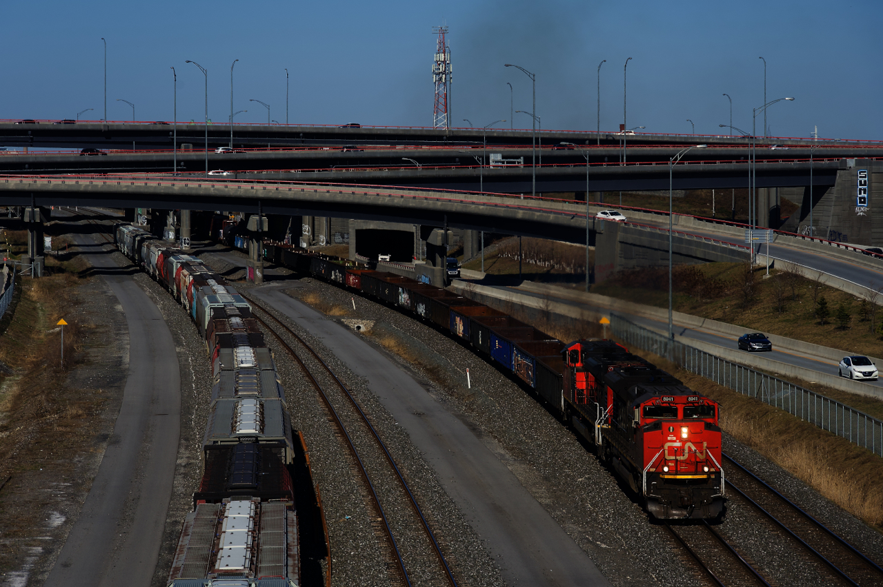 CN 321 has a pair of SD70M-2s (CN 8941 & CN 8844) and 136 cars as it emerges from the Turcot Interchange. At the head end is a big cut of gons, a common sight on this train.