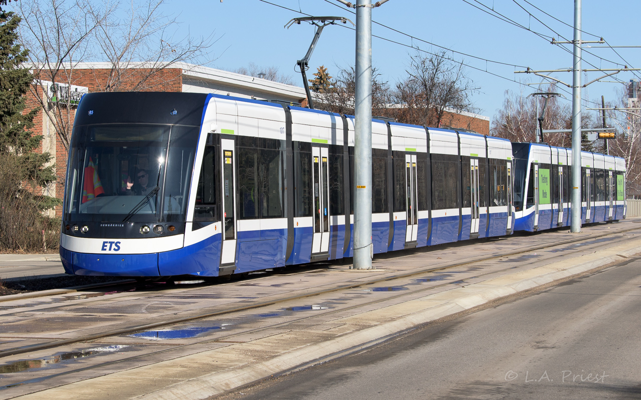 Here is a first for people who like them. The new street level LRT has been testing for a few months now. I'm a little surprised no one has caught this already. It's a short walk from my house and I went to the tracks on this sunny day to grab some shots. Edmonton drivers are not used to turning right and having a train, which has the right of way, going through the intersection. The LRT wins every time and this has happened several times already. Besides the accidents, I'm amazed it is running, this project has been delayed for 2 or more years with repeated delays and setbacks. The last was a very large number of cracked piers on the Argyll road overpass (and beyond) that had to be fixed up. It's testing now and go right on ahead and give this photo the half star it deserves. :^)