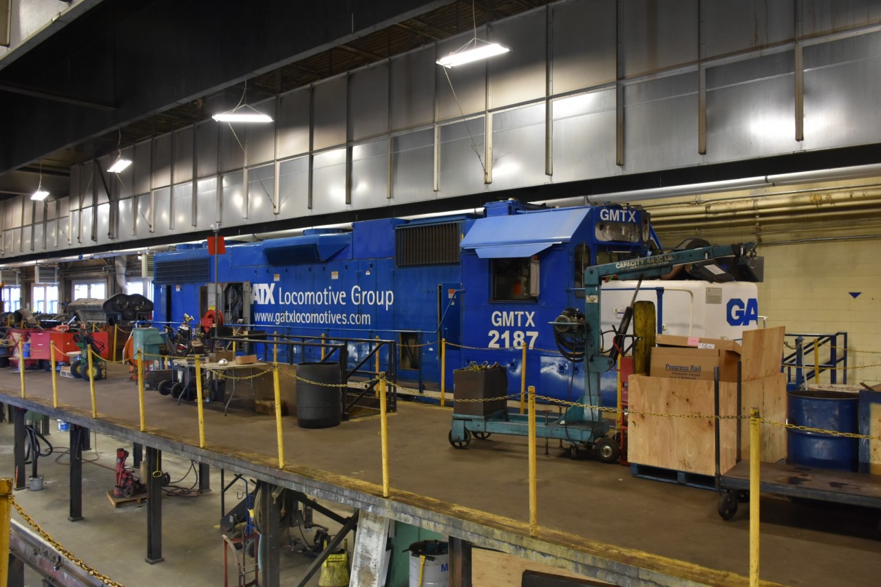 GMTX 2187 GP38-2 (ex-LLPX 2332, exx-GMTX 2187, exxx-CR 8022, exxxx-EMDX 822, nee-PC 8022) is getting a little TLC inside the ONR diesel shop at North Bay, ON April 13, 2023. 
GMTX 2187 was one of many locomotives inside the shop during my tour of the facility, with many more waiting their turn outside.