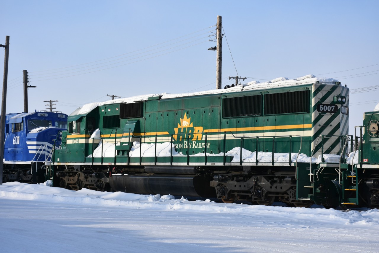 Well, after all, it was Saint Patrick's Day, and there in the middle of a string of new blue and grey HBR power was this 'colour of the day' locomotive so I snapped it for posterity. 
HBRY 5007, an EMD SD50 (ex-NREX 9844, exx-UP 9844, exxx-UP 5055, nee-MP 5055) was shut down in the HBR diesel shop yard along with more than a dozen other new and old HBRY units.