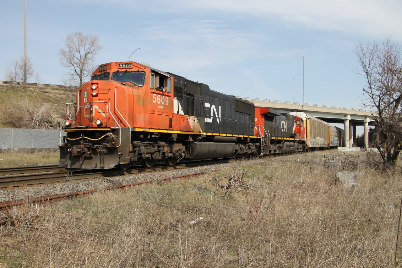 A weathered looking CN 5609 exits out from under the Plains Road overpass with less that 1/2 a mile to the junction with the Oakville Sub. at Burlington West.
