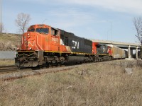 A weathered looking CN 5609 exits out from under the Plains Road overpass with less that 1/2 a mile to the junction with the Oakville Sub. at Burlington West.