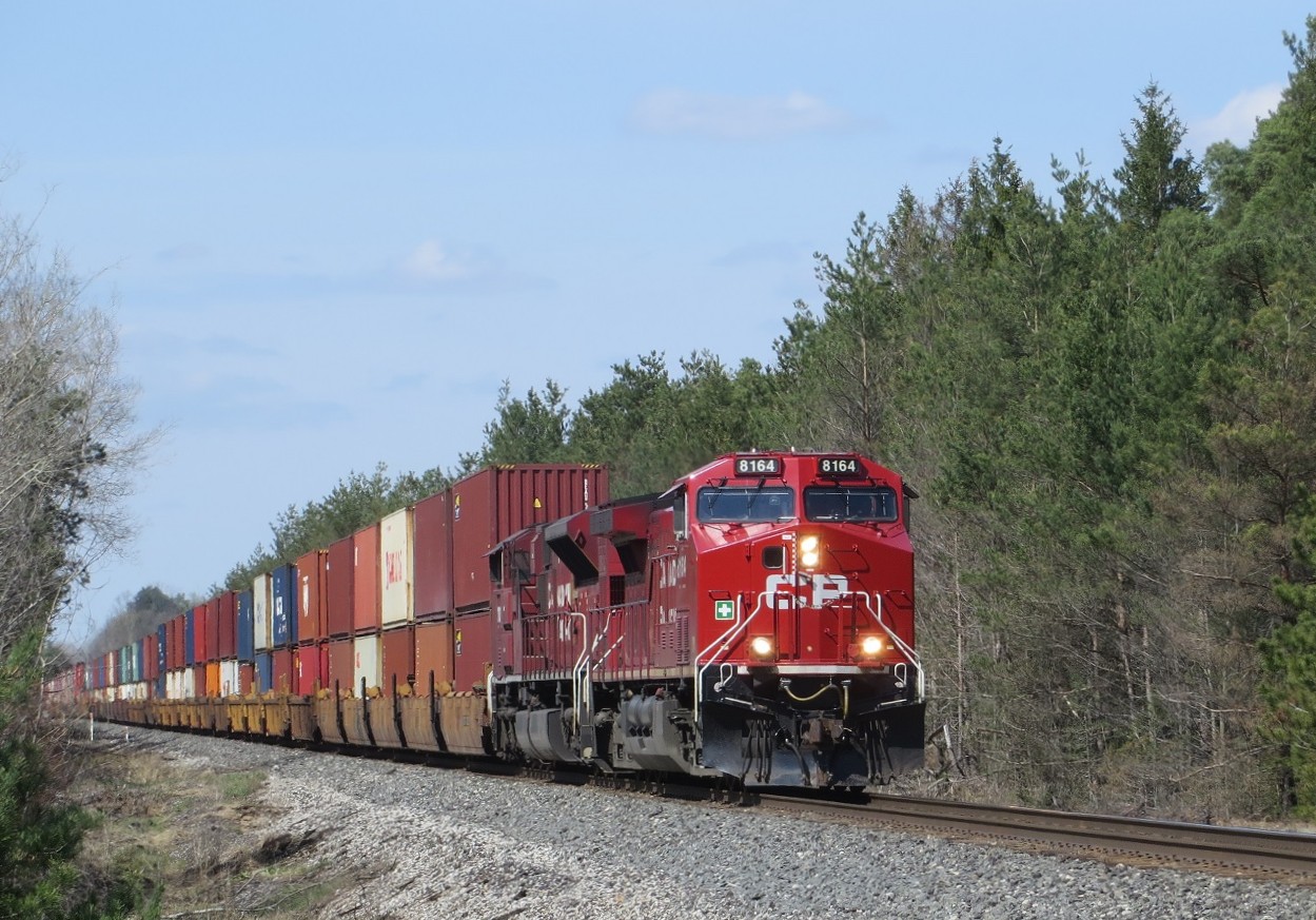 Approaching the Highway 26 crossing, 8164 and 7000 roll a long intermodal south with 8008 pushing on the rear.