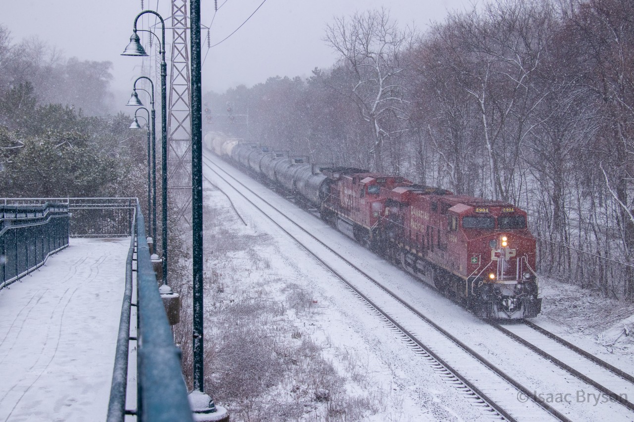 January 25th, 2023 was the first major snowstorm of 2023. The first real snow in nearly a month so I made it a priority to get trackside. Here's CP 230 passing the Summerhill pedestrian bridge as the snow starts to accumulate on the surrounding trees. A pair of CP GEs pull this one (CP 8904 & CP 8034) but that's just about standard at this point.