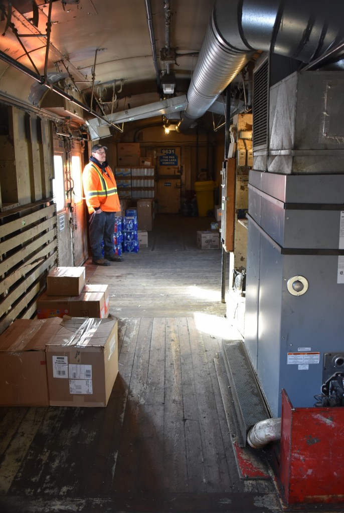 This view is from the A-end doorway of the dual diesel generator enclosure toward the B-end baggage and supply storage area of baggage car KRC 9631 (ex-VIA 9631, exx-CN 9631, nee-CN 9250) NSC built in 1955 on train KRC 291 The Pukatawagan Mixed just minutes before departure from The Pas, MB on March 16, 2023. 
As one of the two generators pounds away behind me, the hot air furnace on the right is keeping the baggage and supplies nice and warm during the trip to Puk. 
I was so fortunate to be offered a personal tour of this unique mixed-train consist by a local KRC employee while it was being prepared for departure. Something completely unexpected but thoroughly appreciated! 
Another great experience on my 2023 winter voyage to Churchill and return. :-)