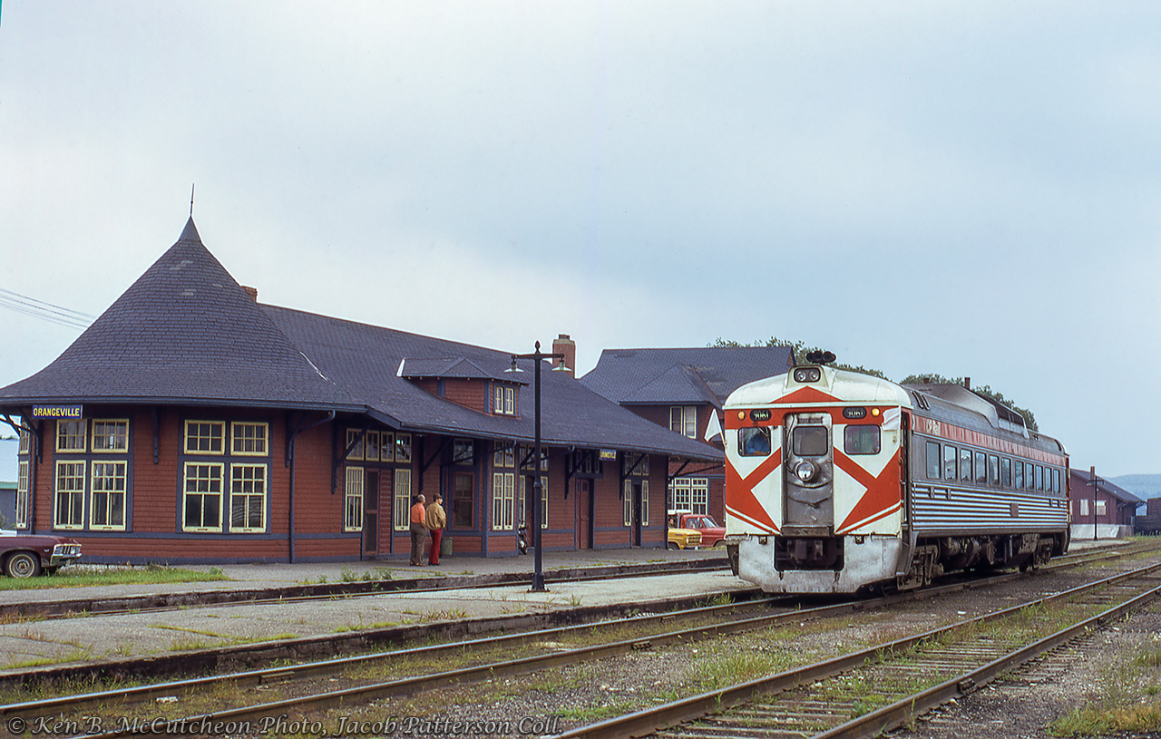 Canadian Pacific RDC-1 9061 pauses at Orangeville during a Toronto - Owen Sound excursion.  Facilities including the 1906 station, bunkhouse, and freight shed fill out the scene.  Seeing its last regularly scheduled train on October 30, 1970, the station would remain on this site into the mid-1980s when it was relocated a few blocks north to 35 Armstrong Street.  Over the last three decades it has played host to various restaurants, most recently the Barley Vine Rail Co.  The Orangeville bunkhouse, originally built as a restaurant in 1943, survived into the OBRY era before succumbing to a fire on March 21, 2006.CPR 9061, built in 1957, would be sold to VIA in 1978 and rebuilt to VIA 6142 in 1981.  6142 was part of a batch of thirteen RDC-1s purchased by Dallas Area Rapid Transit (now Trinity Railway Express) in 1993, being renumbered to TRE 2002.  Ten of these thirteen RDCs were sold in 2017 to AllEarth Rail of Vermont as AERX 2002. AllEarth Rail is a passenger equipment company aiming to develop passenger services throughout the state.Ken B. McCutcheon Photo, Jacob Patterson Collection Slide.