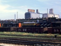 A nice selection of power lays over at CN's Spadina Roundhouse locomotive servicing tracks in downtown Toronto. Visible in the middle is Ontario Northland FP7 1518 (a regular visitor to Spadina Roundhouse off the "Northland" ONR-CN pooled passenger train) coupled to CN FPA4 6776, its likely running mate. RS18's 3726 and 3123 bracket RS10 3083 (whose short hood ended up as a spare at Moncton NB shops by 1975, after the 244-fleet was retired). A CN 1900-series GMD-1 is also visible in the distance. 
<br><br>
In the foreground are some CN "GS" bottom-dump gondolas. In the background, the old Maple Leaf Mills elevators on the harbourfront (opened in 1928 as Toronto Elevators Ltd with a 2 million bushel capacity, demolished in 1982-83. The VIA-CN Spadina facilities would follow a similar fate a few years later).
<br><br>
<i>Original photographer unknown, Dan Dell'Unto collection slide.</i>

