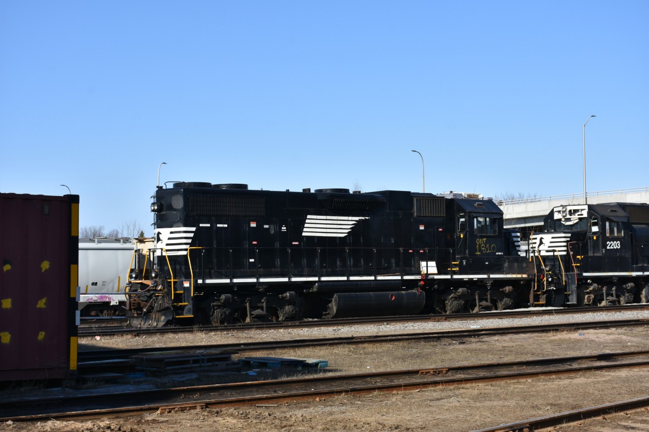 ONT 1810 GP38-3 (ex-NS) sits outside the ONR diesel shop in North Bay, ON on the morning of April 13, 2023. ONT 1810 is coupled to three other ex-NS units, all patched with new ONT numbers (ONT 2203, ONT 2122, ONT 2124).
The quartet of ex-NS units are all waiting their turn to get inside for some service, maintenance, repairs, and maybe a fresh coat of paint before hitting the road on their new territory.