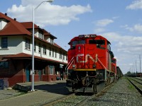 Westbound coal train bound for Ridley Terminal Prince Rupert sits in front of the station during a crew change. The large station at Smithers was McBride to Prince Rupert division Headquarters till circa.1960 when division offices were moved to  Prince George. It is still home base for train crews