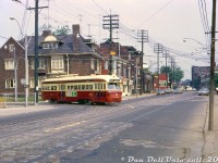 TTC PCC 4338 has just departed the recently opened <a href=http://www.railpictures.ca/?attachment_id=51391><b>Dundas West Subway Station</b></a> (out of frame to the left), and is turning off Edna Avenue onto Dundas Street West to head south/east across the city on the Dundas route, via downtown, to Broadview Subway Station in the east end.
<br><br>
In the background, Dundas Street continues north to <a href=http://www.railpictures.ca/?attachment_id=35760
><b>West Toronto ("The Junction" neighbourhood)</b></a>, along with the Dundas streetcar trackage to <a href=http://www.railpictures.ca/?attachment_id=36016
><b>Runnymede Loop</b></a>. Streetcar service north/west of Dundas West Station would continue for two more years until being replaced with a trolleybus service in May 1968.
<br><br>
<i>Original photographer unknown, Dan Dell'Unto collection slide.</i>