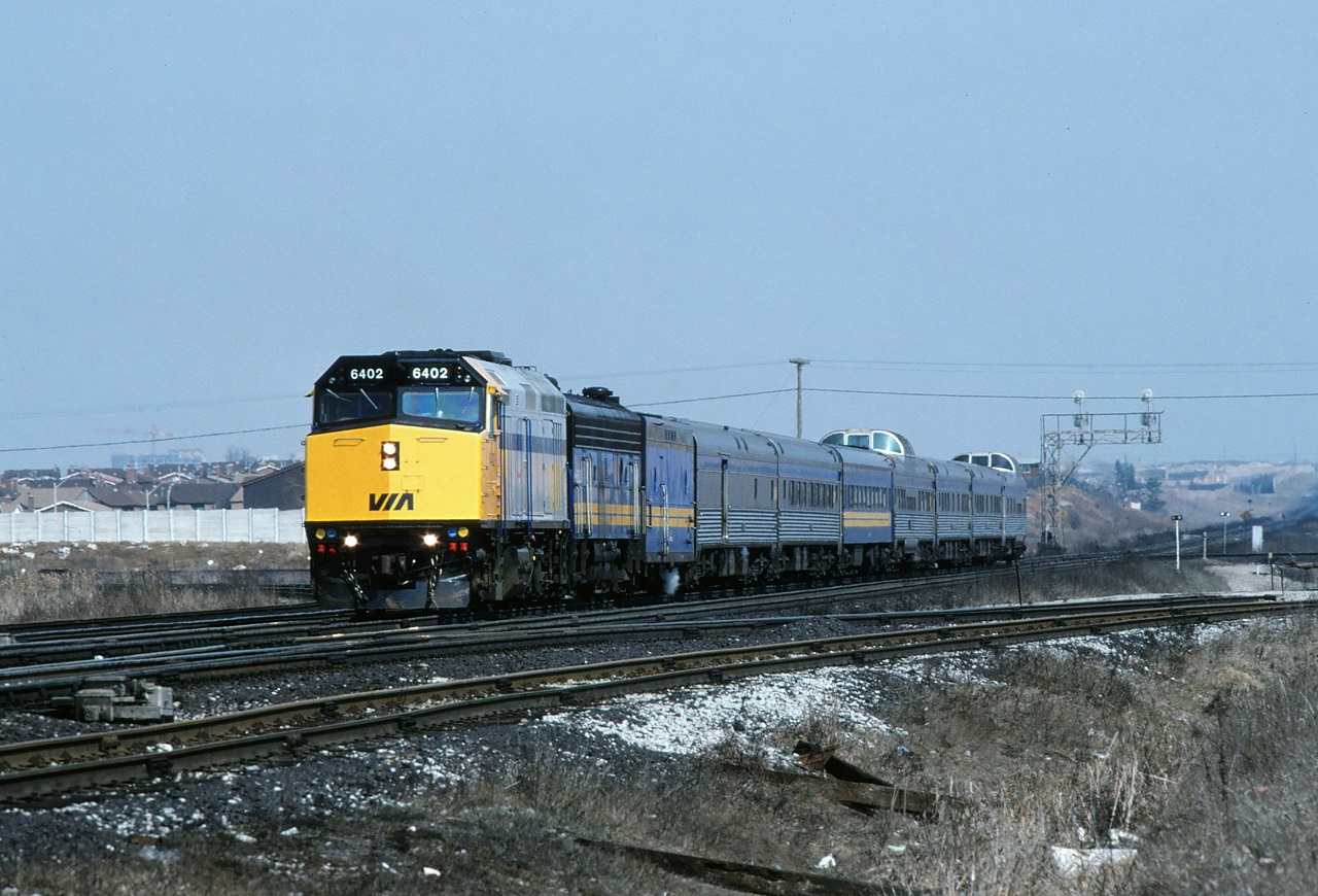 VIA's westbound Canadian, train 9, slows after crossing the diamond at Snider.  The train will pull past my location, back around the connecting track on the right to the Newmarket Sub before it finally heads north.  The new F40s were just beginning to make their appearance.  Hard to believe they are still pulling the Canadian more than 35 years after this photo was taken.