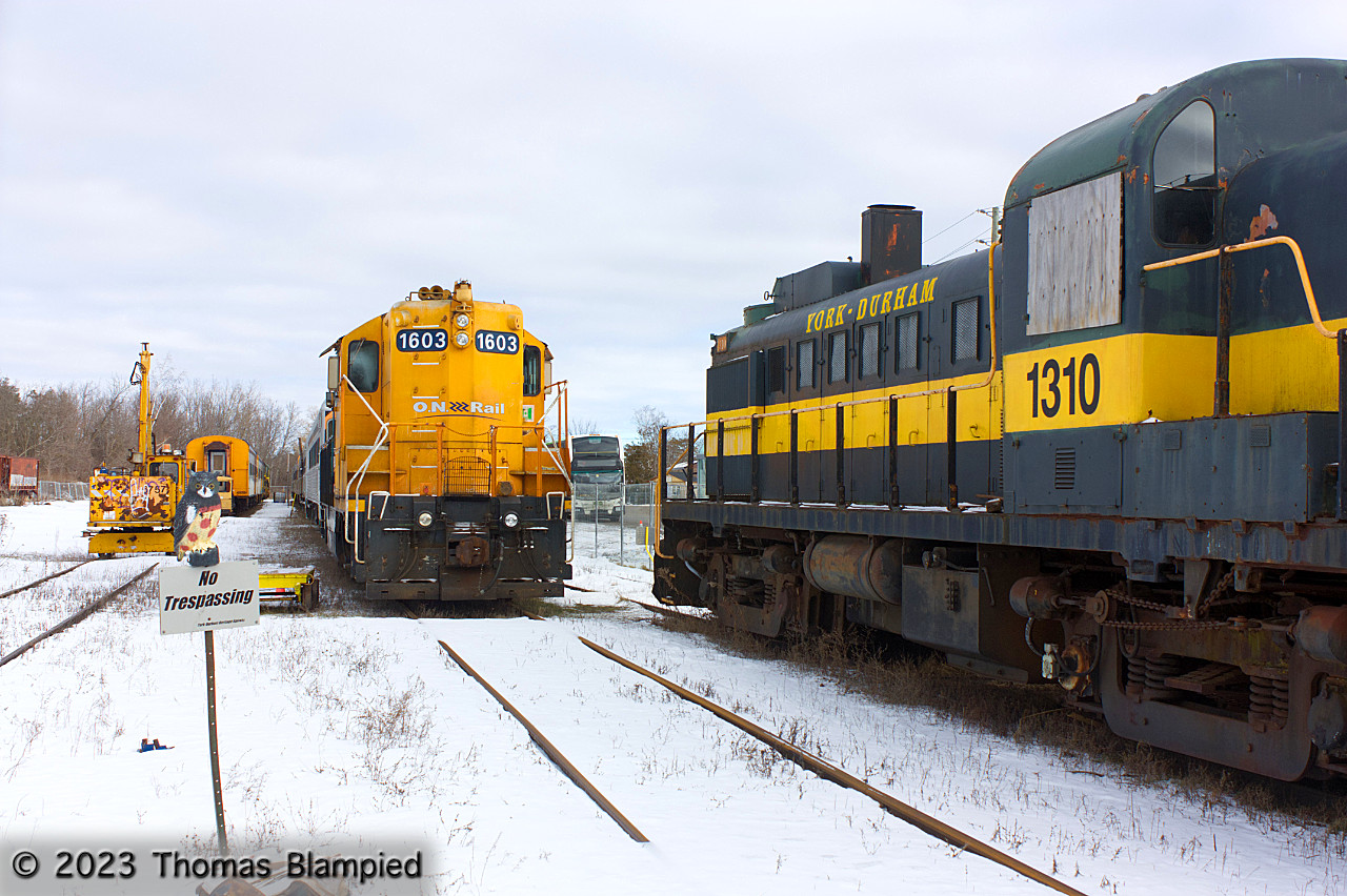 2022 was not a good year for the York-Durham Heritage Railway: the continued pandemic, a tornado, and significant ticket disputes made the year one to forget for the tourist operation. However, from a railfan perspective, the end of 2022 also saw the railway borrow 1603, the ONR's rebuilt GMDD GP9, to alleviate the YDHR's power shortage. Seen at Uxbridge, 1603 has been reunited with 1310, a former ONR MLW RS-3 which left the ONR roster back in 1985. After a stint with Abitibi Price, the 1310 arrived in Uxbridge in 1997. The loan of 1603 brings the YDHR's roster of ONR equipment temporarily to six: 1603, 1310, and four passenger cars, two of which are visible in the left of this image behind the MOW crane and the yard's ever-watchful owl.
