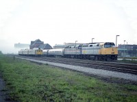 I don't remember, but looking at the photo it must have been a strange sort of a day. Overcast, yes, but I do not recall such fog coming off the Niagara River as can be seen in the background. After all, it is around 1700 hrs. Not a morning mist.
AMTK 296 as #98, Toronto bound; for some reason this afternoon being assisted by VIA 6423. Of interest this is the unit that would be wrecked at a violent incident in Thamesville, Ontario  in April of 1999.
The Budds are overnighting...........they will be out as #636, the morning train to Toronto.