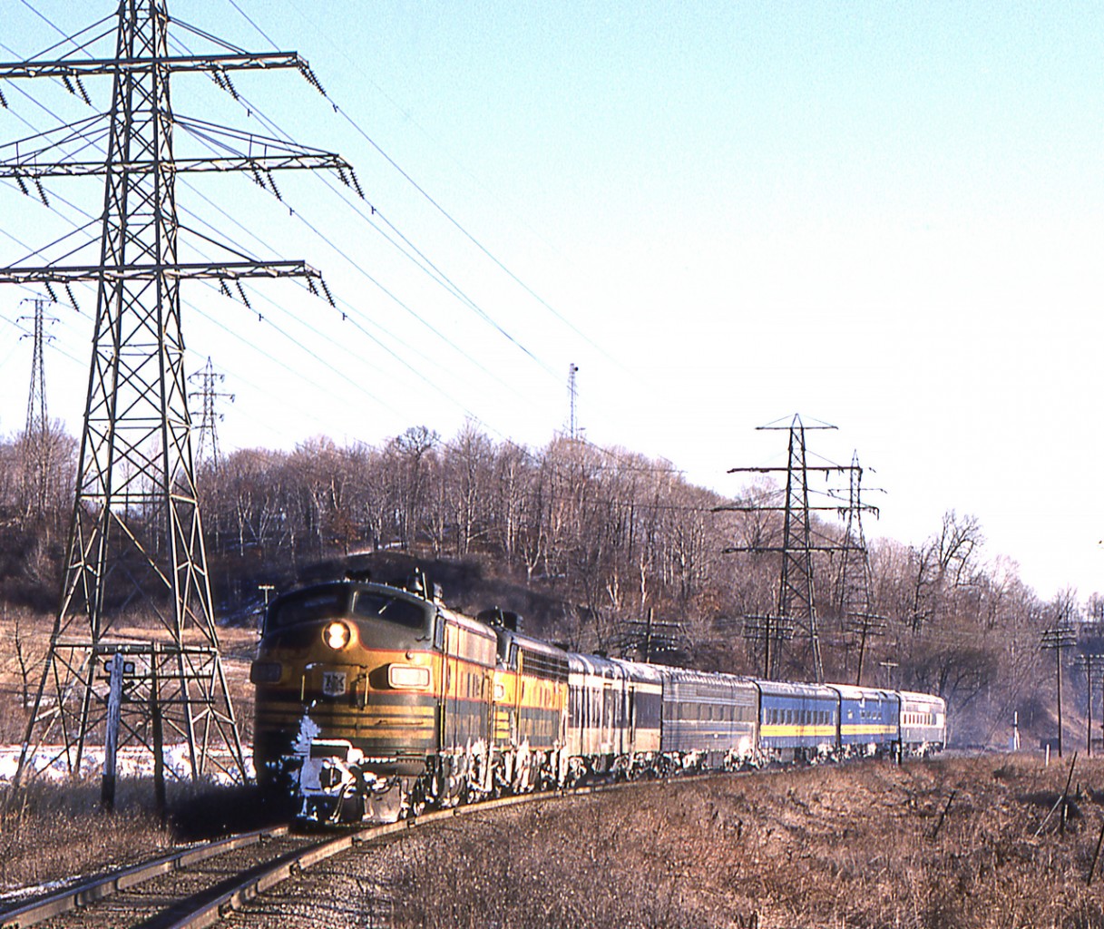 Peter Jobe photographed VIA train #128 headed by Ontario Northland 1521 and Ontario Northland 1509 at Pottery Road in Toronto on March 11, 1980.