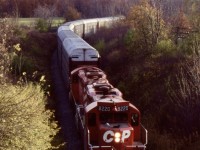 The gradual retirement of CP's RS18's and C424's pushed the GP9U's to take over many more assignments. At this time the "Ham Turn" was kind of an interesting job. The old TH&B Aberdeen yard had recently been almost cut in half and the power that was typically kept there like the MLW's, was moved to Kinnear. The old TH7B car shop at the time was being used for fixing auto racks, most destined for the Toyota plant in Cambridge. Unfortunately the old shop was in bad shape and future developments as far as the steel transfer facility would force its demolition. At this time the shop was still active, and this days "Ham Turn" has a good cut of auto racks from there heading up the Niagara Escarpment towards Cambridge, with a pair of GP9U's for power. The city of Hamilton can be seen in the background. The "Ham Turn" would still see another decade before being abolished along with a number of other trains. 