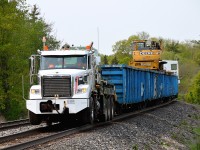 Looking east at Canyon Rd in Campbellville; saw double red on the south track and assumed it to be for #137. I was rather surprised by the gates going down behind me when walking back to the car, and along comes the Brandt Railtruck on the north, moving along eastward at a pretty good clip behind a highrail truck.  Caught off guard but not a bad shot. (the 137 came shortly after, around 13:20 hrs, with CP 8120, 7010)