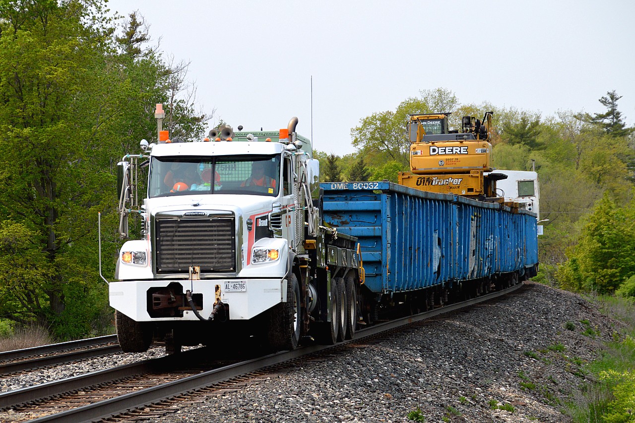 Looking east at Canyon Rd in Campbellville; saw double red on the south track and assumed it to be for #137. I was rather surprised by the gates going down behind me when walking back to the car, and along comes the Brandt Railtruck on the north, moving along eastward at a pretty good clip behind a highrail truck.  Caught off guard but not a bad shot. (the 137 came shortly after, around 13:20 hrs, with CP 8120, 7010)