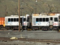 CN 10800 & CN 10900 (ex-Kaoham Shuttle) aka TU-108 and TU-109, built in 1999 by Jim Busby Services of California, sit on a deadline track near the Work Equipment Repair Facility in Kamloops Yard on May 3, 2023 <br>
Each time I have passed through Kamloops North in the past 2-3 years, these vehicles show continuing signs of being slowly cannibalized for parts.