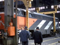 Stories of its existence floated around online for years, but actual photos were scarce:<br><br>A rare view of Canadian Pacific's "newest" C-Liner: former CN CFA16-4 9344 sits in the tight bays of CP's Ogden Shops as shop crews get the unit ready to be lifted off its trucks by the large overhead shop crane. This unit, acquired by CP after it was retired by CN, was one of only two 9300-series CFA16-4's to get CN's new paint scheme. Most of CN's fleet of FM/CLC units were retired in the mid-late 1960's, stripped for parts at Montreal, and the carbodies sent to <a href=http://www.railpictures.ca/?attachment_id=18682><b>reclamation yards such as London</b></a> for final scrapping.<br><br>The fate that befell 9344 took a slightly different turn however, when CP wrecked one of their own C-Liners. CP CPA16-4 4054 was wrecked in January 1967 when it ran into a rock slide and hit several very large boulders on the tracks, significantly bending its frame behind the cab. CP, whose FM/CLC fleet was still a going concern at the time, purchased the carbody of retired CN 9344 in order to repair their 4054 (creating a new "CP 4054:2" from the CN unit). Apparently there were more compatibility issues between 9344 and the rest of CP's fleet than first thought, and the project was never carried through. CP FM/CLC cab unit overhauls were curtailed a year or two later, and the remaining units were run until attrition and eventual mass retirement in 1975 <a href=http://www.railpictures.ca/?attachment_id=47531><b>ended CP's FM/CLC fleet</b></a>. Both the unrebuilt CN 9344 and the wrecked CP 4054 were scrapped.<br><br><i>Original photographer unknown, Dan Dell'Unto collection slide.</i>