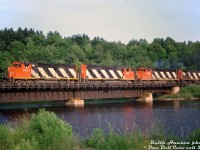 CN GP40-2L(W) units 9574, 9594, and 9420 team up with M420 2532 on a northbound freight, crossing the bridge over the Seguin River at Mile 149.20 of the Bala Sub in Parry Sound.<br><br><i>Keith Hansen photo, Dan Dell'Unto collection slide.</i>