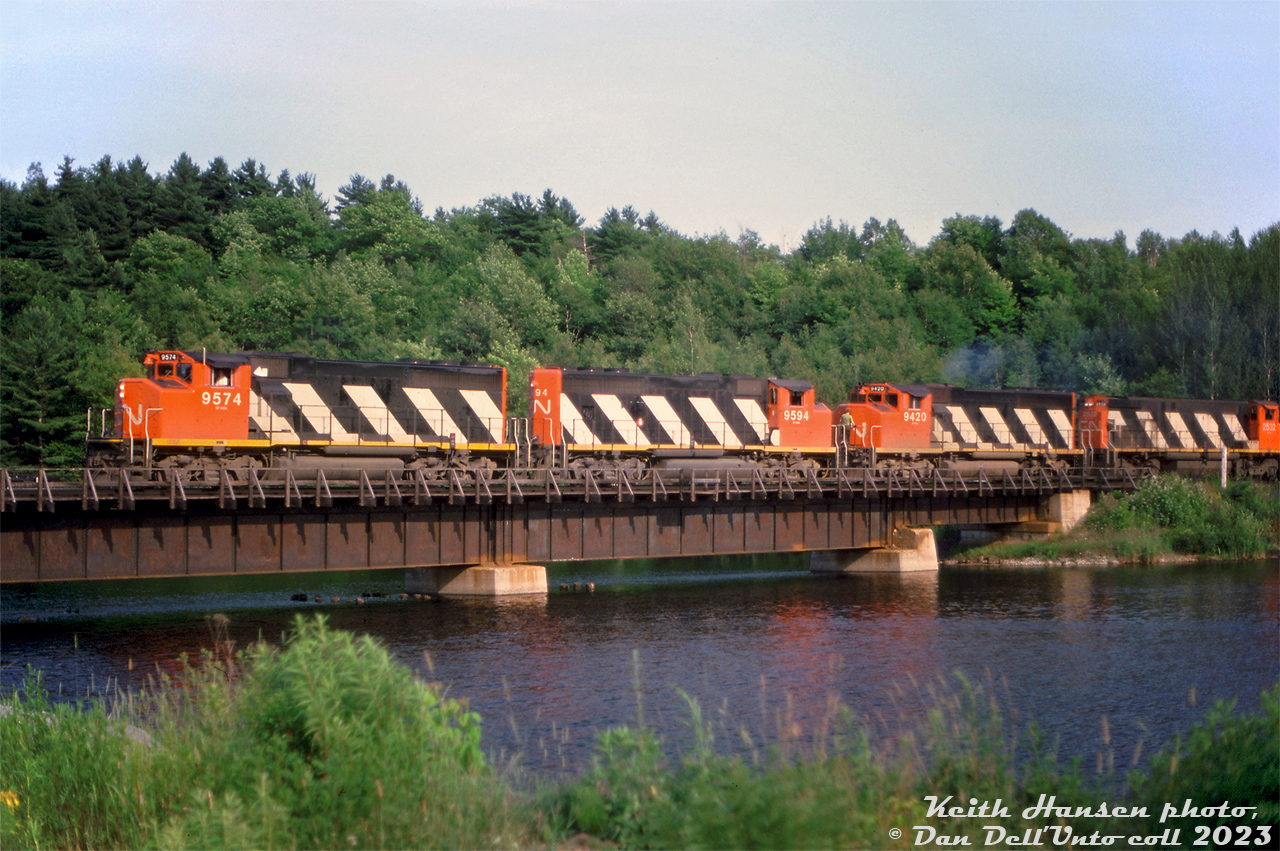 CN GP40-2L(W) units 9574, 9594, and 9420 team up with M420 2532 on a northbound freight, crossing the bridge over the Seguin River at Mile 149.20 of the Bala Sub in Parry Sound.Keith Hansen photo, Dan Dell'Unto collection slide.