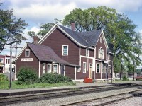 About time I posted another railroad station shot.    I've always loved this particular place.  Classic old style, all wood and living quarters built in. Note the red saltbox out front. Don't know when this station was built, (oldest photo I have seen dates 1905)  but the Petitcodiac and Elgin Branch Railroad Company was the first thru here in 1876; a northward line off to Havelock was laid in 1885 but good money was never really made. It was pulled up in 1993 and the Intercolonial took over the main line in 1919. 
When this photo was taken, the station was served by two RDC powered trains each way daily. By the mid-80s it was just the one, with the  VIA 'Atlantic', while seen, did not stop.
With the so-called 'progress' on the railroad scene, the building was considered redundant and torn down in the late 1980s. I haven't the actual year, and am curious.
It is a shame this village has lost a landmark.