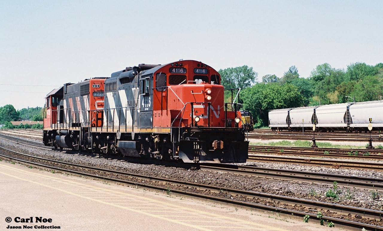 CN 585 with 4116 and 4728 prepares to switche industries in Brantford, Ontario seen arriving in the yard on the Dundas Subdivision.  At the time, this local operated from London as far east as Paris and Brantford, usually making an appearance during the afternoon. HLCX 113 and RaiLink 1751 were the Southern Ontario RaiLink power in the yard in Brantford on this day.