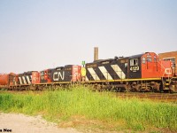 CN 421 is pictured at the Kitchener yard with a trio of GP9RM’s on a summer evening that includes; 4129, 7038 and 4111. The car immediately behind the power possibly came from Babcock & Wilcox on the Fergus Spur in Cambridge. During the summer of 1993, solid sets of GP9RM’s would often power 421 from MacMillan Yard in Toronto. 