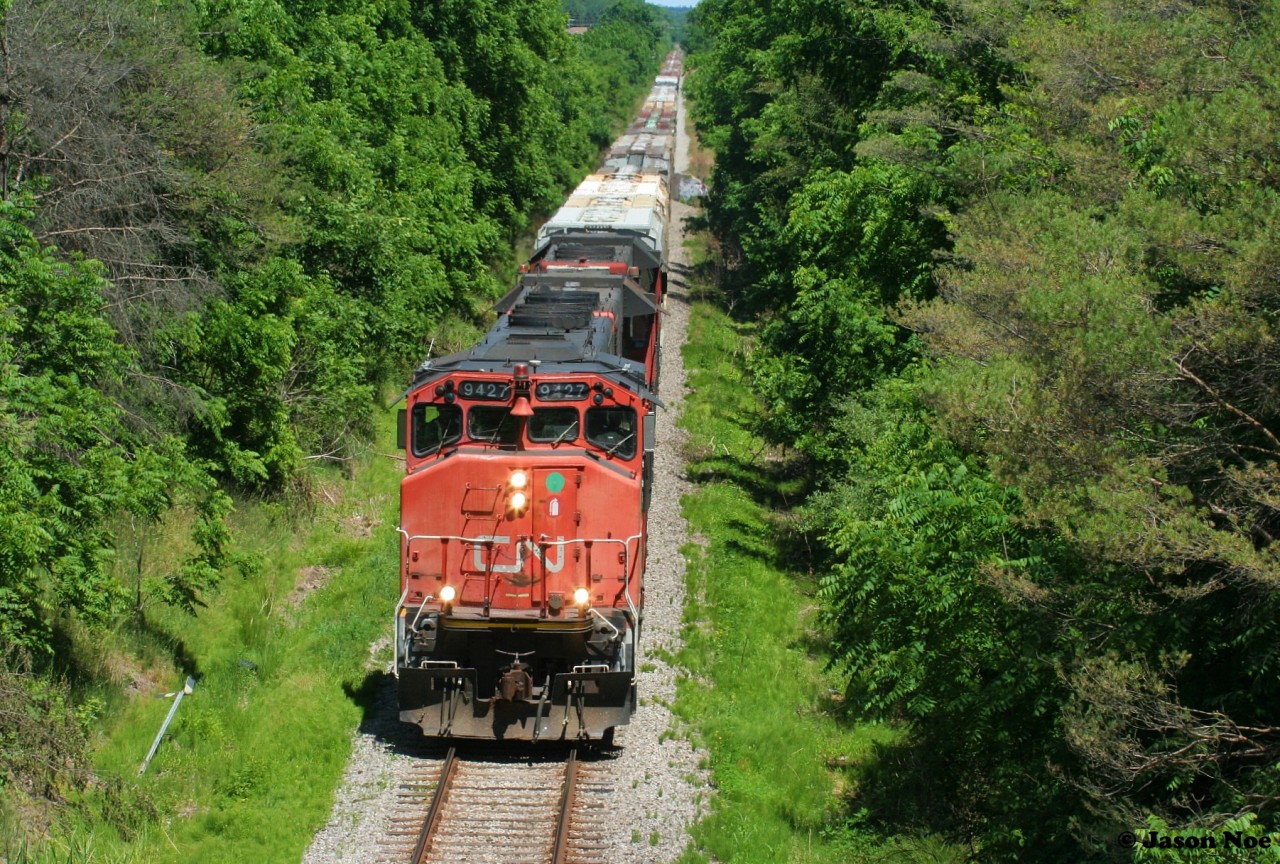 CN L568 is viewed just west of the town of New Hamburg, Ontario as it heads to Stratford on the CN Guelph Subdivision with 9427, 7521 and 4732 on a summer afternoon.