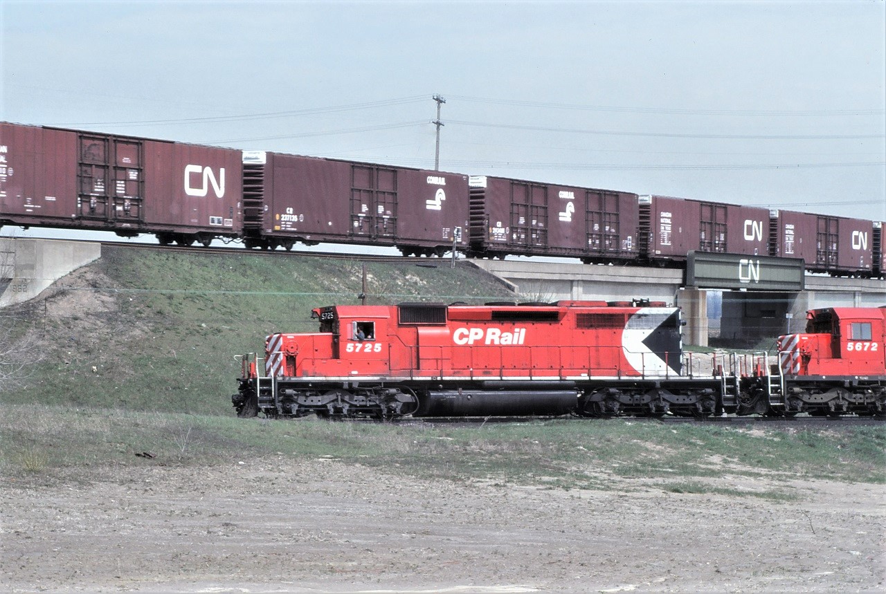 In a not photoshopped photo, a northbound CP freight with 5725 leading ducks under a westbound CN freight at CN Humber on April 28, 1984.
