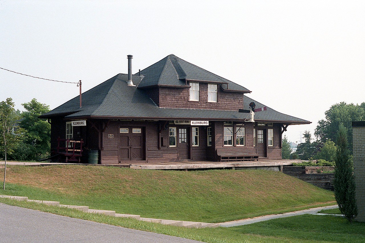 Another photo for the Station Gallery:  The former CP Kleinburg station is shown after it had been moved to a permanent location on the grounds of the Kleinburg Public School. Station has been fully restored and is now the "Railway Station Scout House". The original station was built approximately 1870 when the narrow gauge Toronto Grey & Bruce was pushing its way north from Toronto.  CP took over the line in 1883 and when this station burned, the one shown here was constructed in 1908. Kleinburg was by 1921 a stop for 13 passenger trains daily ! Time marched on, passenger traffic dwindled after Hwy 400 opened in 1952 and the station closed in 1964. In 1976 the freight house was torn down, and the station moved to where you see it now. Kleinburg is now part of Vaughan.