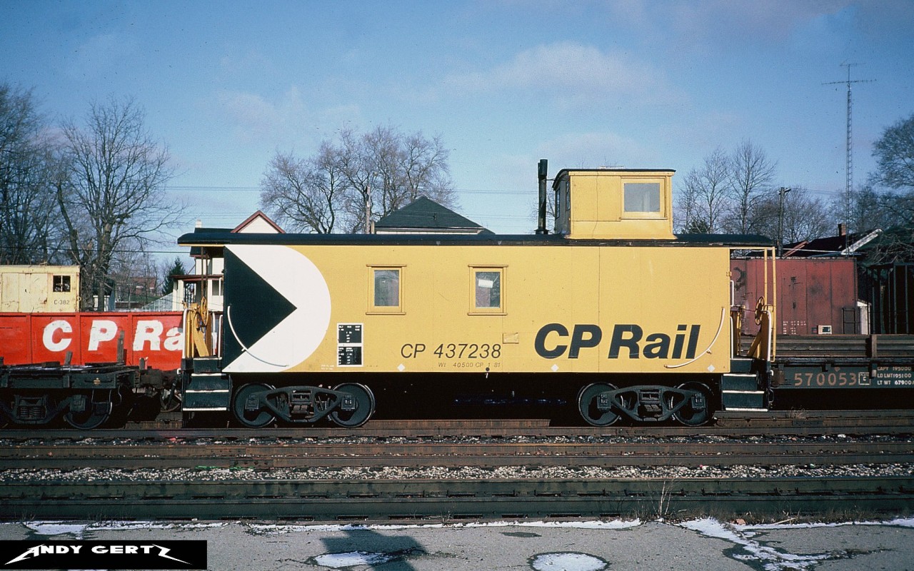 Photographed while waiting for trains on the CP Galt Subdivsion, CP wooden caboose 437238 is at Galt, Ontario in winter 1982.
