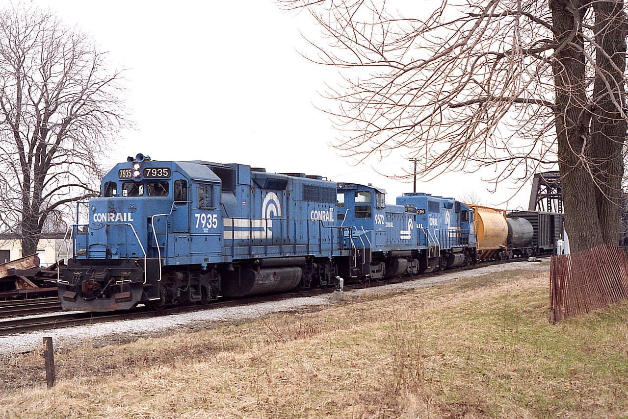 Quite often the same group of locomotive models (GP 38s and SW 1500s) were seen on the daily transfer from Buffalo to Fort Erie and return, but the pool must have consisted of perhaps a dozen units so at least the combination of locos remained interesting. On this early spring day Conrail 7935, 9572 and 7936 provide the power. Traffic is dropped and then, with 7936 as leader; traffic for the USA would be picked up. This all was usually completed within the hour.