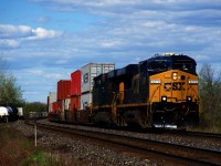 After switching to 100% CN power for about six months, CSX power returned to run-through trains CN 326/327 about three weeks ago. Here a repainted ES40DC leads CN 327 around a curve as it approaches Coteau, where it will leave the Kingston Sub for the Valleyfield Sub. At left are a few cars going to or from Ronsco.